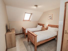 A bedroom with two beds and a chest of drawers at Wheelhouse Cottage in Sneatonthorpe near Whitby