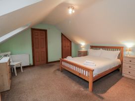 A bedroom with a bed and furniture at Wheelhouse Cottage in Sneatonthorpe near Whitby