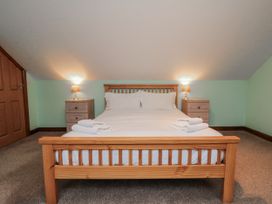 A bedroom with a double bed and nightstands at Wheelhouse Cottage Sneatonthorpe near Whitby