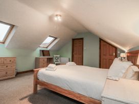 A bedroom with a bed and furniture at Wheelhouse Cottage Sneatonthorpe near Whitby