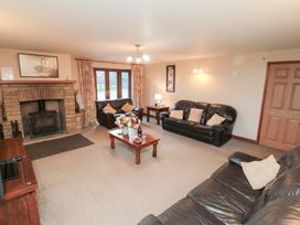 A living room with a fireplace and sofas at Wheelhouse Cottage in Sneatonthorpe near Whitby