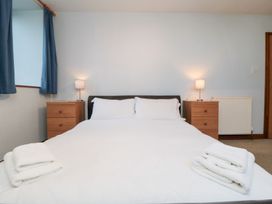 A bedroom with a bed and bedside tables at Wheelhouse Cottage Sneatonthorpe near Whitby