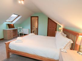 A bedroom with a bed and desk at Wheelhouse Cottage in Sneatonthorpe near Whitby