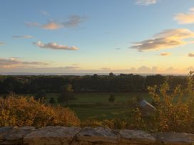 A landscape view with trees and a house at Hafod Y Graig in Morfa Bychan
