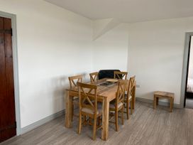 A dining room with a table and chairs at Hafod Y Graig in Morfa Bychan