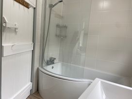 A bathroom with a bathtub and shower at Hafod Y Graig in Morfa Bychan