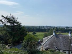 A view of a house and fields from a hill at Hafod Y Graig Morfa Bychan