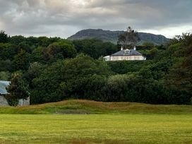 A house surrounded by trees and a field at Hafod Y Graig in Morfa Bychan