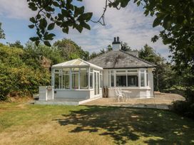 A house with a conservatory and garden at Seaview Hafod Y Graig in Morfa Bychan