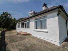 An exterior view of a house with windows and a patio at Seaview Hafod Y Graig Morfa Bychan