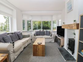 A living room with sofa and coffee table at Seaview Hafod Y Graig in Morfa Bychan