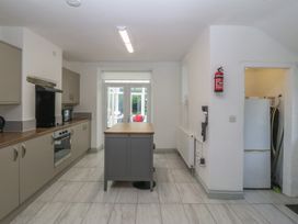 A kitchen with appliances and an island at Seaview Hafod Y Graig Morfa Bychan