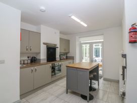 A kitchen with cabinets and appliances at Seaview Hafod Y Graig in Morfa Bychan