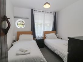 A bedroom with two beds and a window at Seaview Hafod Y Graig in Morfa Bychan