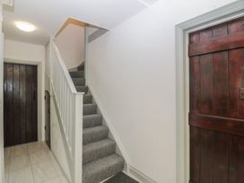A staircase and door in a hallway at Seaview Hafod Y Graig in Morfa Bychan