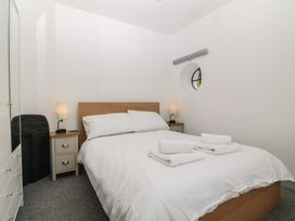A bedroom with a bed and bedside table at Seaview Hafod Y Graig in Morfa Bychan