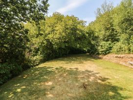 A garden with grass and trees at Seaview Hafod Y Graig in Morfa Bychan