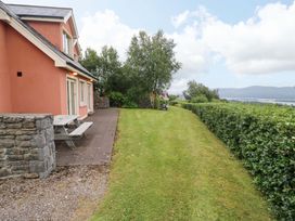 An outdoor area with a house, patio, and grass at 25 Ring of Kerry Holiday Cottages, Kenmare