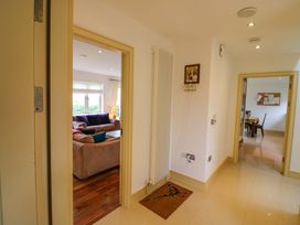 A hallway with a door leading to a living room and a dining area at 25 Ring of Kerry Holiday Cottages, Kenmare