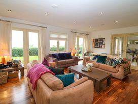 A living room with sofas and a coffee table at 25 Ring of Kerry Holiday Cottages in Kenmare