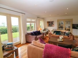 A living room with sofas and a table at 25 Ring of Kerry Holiday Cottages in Kenmare