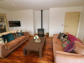 A living room with a sofa and coffee table at 25 Ring of Kerry Holiday Cottages Kenmare