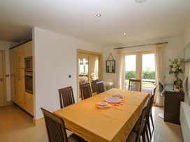 A dining room with a table set for a meal at 25 Ring of Kerry Holiday Cottages Kenmare