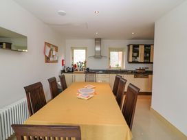 A dining room with a large table and chairs at 25 Ring of Kerry Holiday Cottages Kenmare