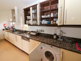 A kitchen with a washing machine and countertop at 25 Ring of Kerry Holiday Cottages in Kenmare