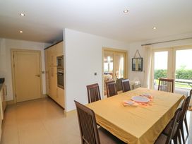 A kitchen with a dining table and chairs at 25 Ring of Kerry Holiday Cottages in Kenmare
