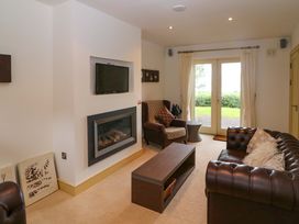 A living room with a television and fireplace at 25 Ring of Kerry Holiday Cottages, Kenmare