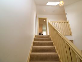 A staircase leading to a doorway at 25 Ring of Kerry Holiday Cottages in Kenmare