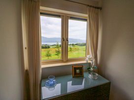 A window with a view and a table with decor items at 25 Ring of Kerry Holiday Cottages in Kenmare