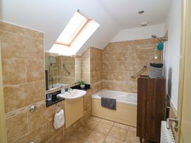A bathroom with a sink and bath tub at 25 Ring of Kerry Holiday Cottages in Kenmare