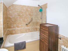 A bathroom with a bathtub and drawer unit at 25 Ring of Kerry Holiday Cottages Kenmare