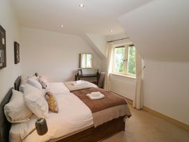 A bedroom with two beds and a desk at 25 Ring of Kerry Holiday Cottages in Kenmare