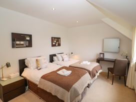 A bedroom with two beds and a desk at 25 Ring of Kerry Holiday Cottages Kenmare