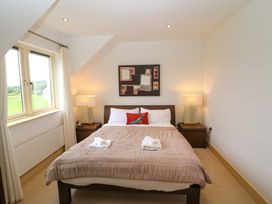 A bedroom with a bed and lamps at 25 Ring of Kerry Holiday Cottages in Kenmare