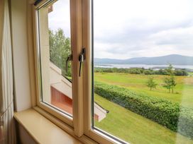 A window showing a landscape view at 25 Ring of Kerry Holiday Cottages in Kenmare