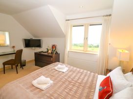 A bedroom with a bed and television at 25 Ring of Kerry Holiday Cottages in Kenmare