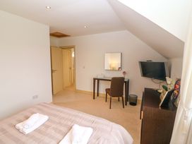 A bedroom with a bed and desk at 25 Ring of Kerry Holiday Cottages in Kenmare