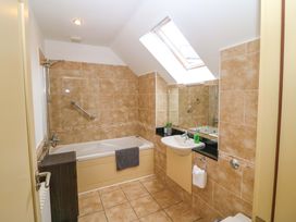 A bathroom with a bathtub and sink at 25 Ring of Kerry Holiday Cottages Kenmare