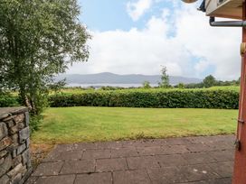 A view of mountains and lake from a garden at 25 Ring of Kerry Holiday Cottages in Kenmare
