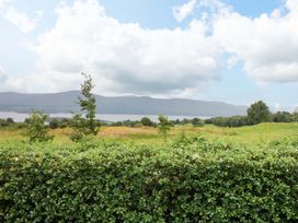 A view of a lake with mountains in the background at 25 Ring of Kerry Holiday Cottages in Kenmare