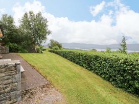 A garden with grass and a hedge at 25 Ring of Kerry Holiday Cottages in Kenmare