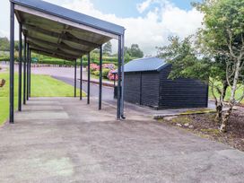 An outdoor area with a shelter and a shed at 25 Ring of Kerry Holiday Cottages
