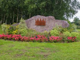 A rock with a crown emblem surrounded by flowers at 25 Ring of Kerry Holiday Cottages