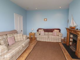 A living room with two sofas and a fireplace at Glen Avon in Seahouses