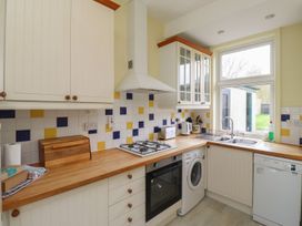 A kitchen with modern appliances and a window at Glen Avon in Seahouses