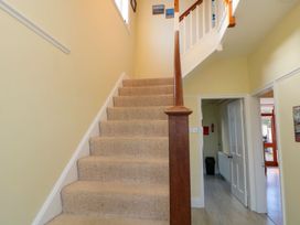 A staircase leading upstairs in the hallway at Glen Avon Seahouses